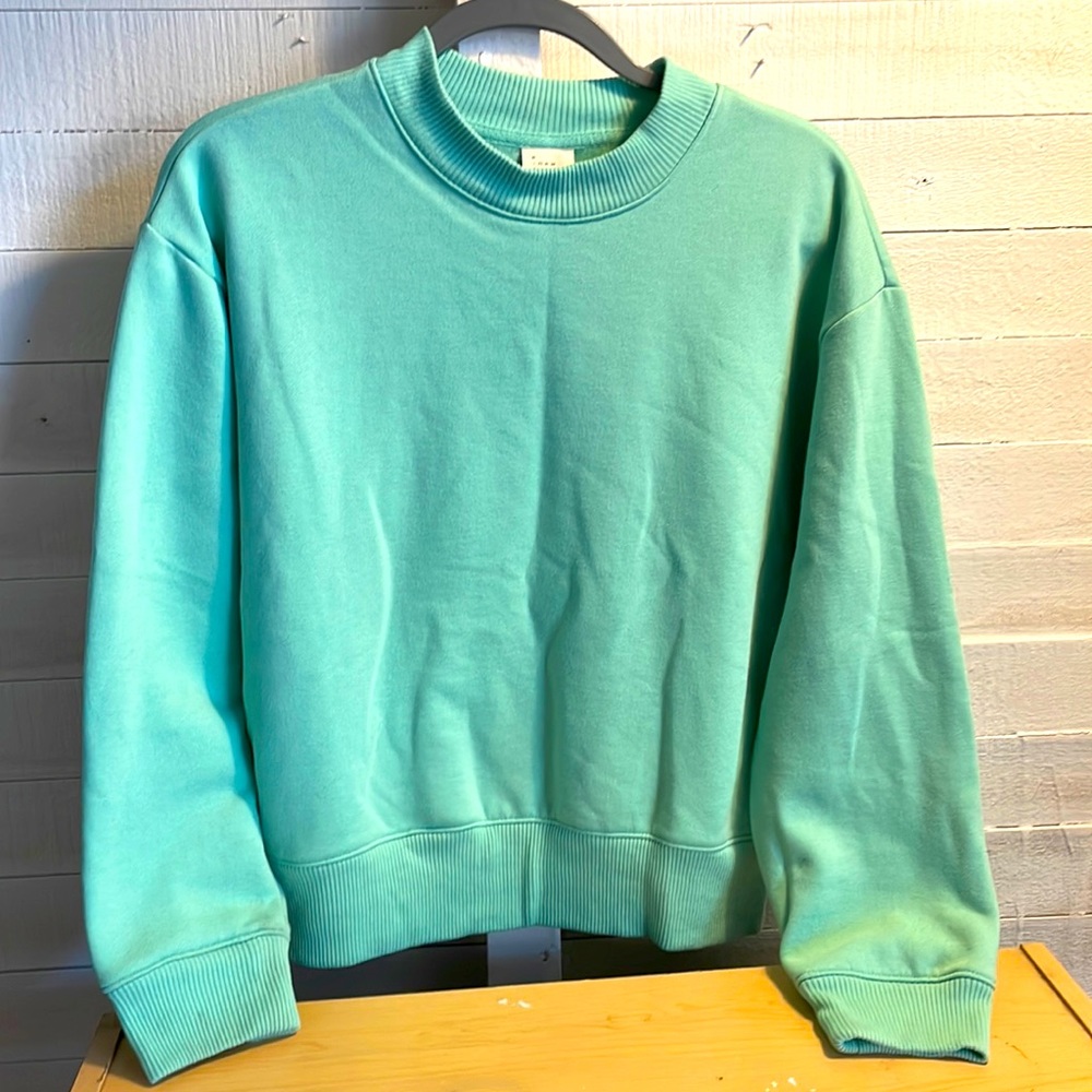 A new day brand, light green size medium sweatshirt, never worn.